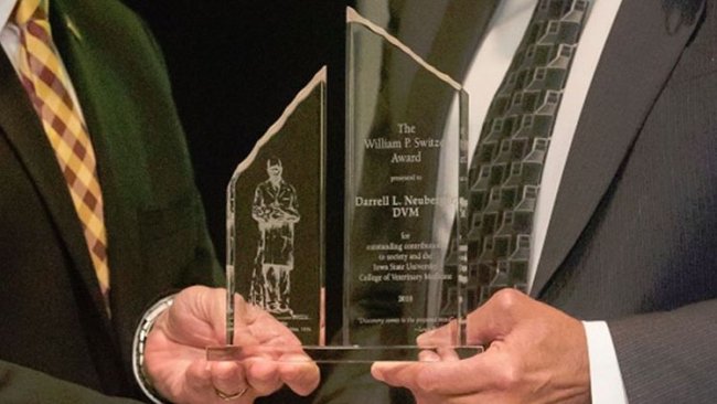 (Left to right) Dan Grooms, Ph.D., dean of the Iowa State University College of Veterinary Medicine, presents Darrell Neuberger, DVM, Tonisity technical services veterinarian, with the 2018 William P. Switzer Award in Veterinary Medicine for his contributions to society and to the college. (Photo credit: Iowa State University)