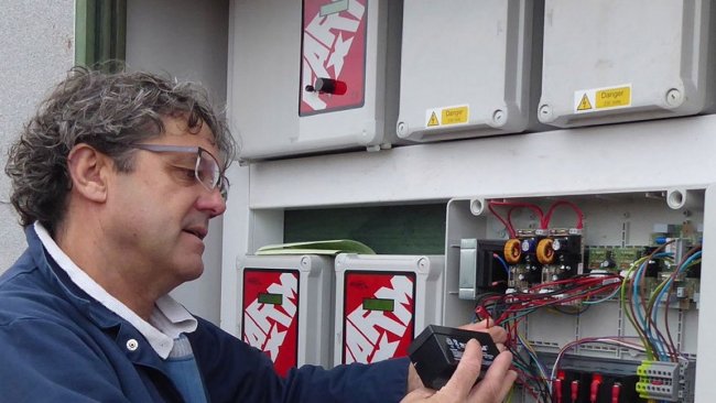 Tim Miller checks a fail-safe battery on a 400-pig place finishing building on a Midlands farm.