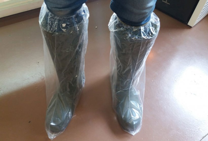 Picture 1. Plastic boots help prevent cross contamination by footwear.
