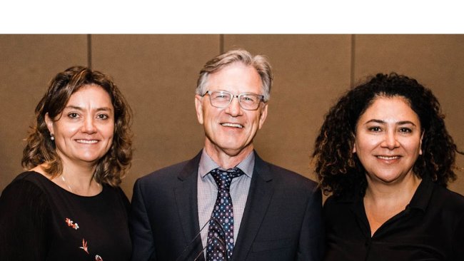 Dr. Nate Winkelman with Dr. Montse Torremorell, UMN (left) and Dr. Lucina Galina, Zoetis (right)