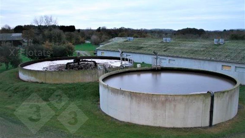 Figure&nbsp;2. Picture of the installation for the biological removal of nitrogen by means of NDN on a swine farm. In the foreground is the denitrification lagoon/reactor and behind it is the nitrification lagoon/reactor, where the aeration system can be seen.
