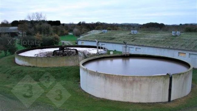 Figure 2. Picture of the installation for the biological removal of nitrogen by means of NDN on a swine farm. In the foreground is the denitrification lagoon/reactor and behind it is the nitrification lagoon/reactor, where the aeration system can be seen.