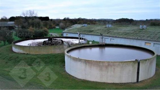 Figure&nbsp;2. Picture of the installation for the biological removal of nitrogen by means of NDN on a swine farm. In the foreground is the denitrification lagoon/reactor and behind it is the nitrification lagoon/reactor, where the aeration system can be seen.
