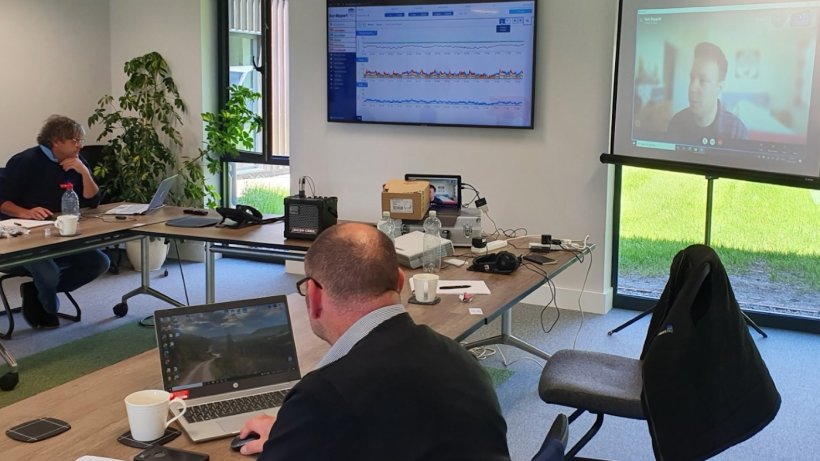 Tim Mill (left) and Hugh Crabtree link up remotely with Kyle Baggott from Dicam Technology Ltd (on screen) to demonstrate the on-farm use of data produced by the Barn Report Pro system
