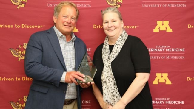 Dr. Scott Dee (left) holds the Distinguished Research Alumni award with CVM Associate Dean of Research Dr. Molly McCue. Photo by Marty Moen.