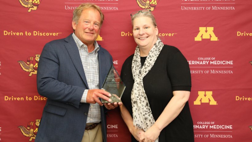 Dr. Scott Dee (left) holds the Distinguished Research Alumni award with CVM Associate Dean of Research Dr. Molly McCue. Photo by Marty Moen. 