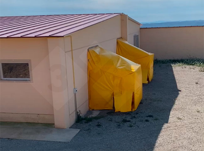 Photo 2. A plastic frame was fitted to the air extraction fans in Barn&nbsp;2 to direct the air to&nbsp;the floor, where large trays containing virucidal disinfectant had been placed.
