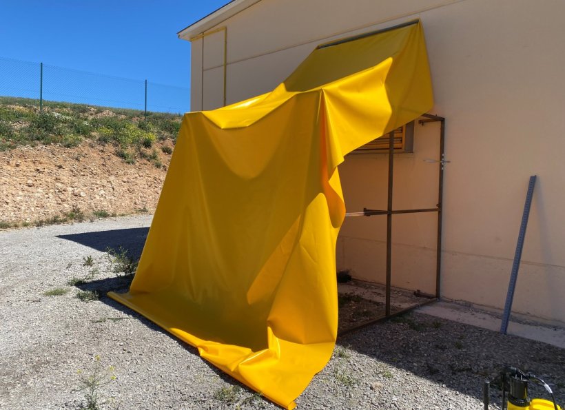 Photo 1. Installation of metal frames at the air vents to support the canvases.

