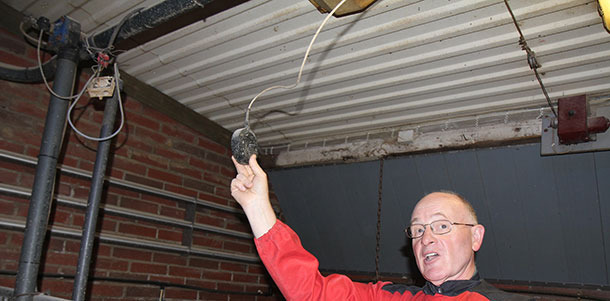 Hugh Crabtree demonstrates the best position of a temperature control sensor — particularly critical with extremes of temperature. The horizontal pipes on the wall carry hot water — necessary to counteract the severe Finnish winters.