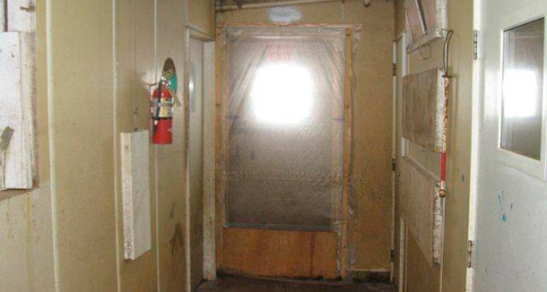 Example of sealed door system that prevent unwanted air transfer and the convenient yet inappropriate movement of personnel between the “clean” (inside) and the “dirty” (outside) zones of the facility